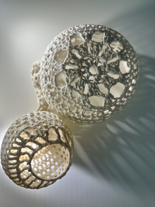 Two spherical porcelain lace sculptures, Confluence series by Aida Izadpanah